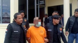 Tersangka JN (47) warga Kecamatan Dabun Gelang-Gayo Lues-Aceh, saat dijemput oleh Tim Opnal Polres Gayo Lues dari ruang tahanan pada Konfrensi Pers di Halaman Mapolres Galus, Jumat (21/11/2025) |doc|insetgalus|